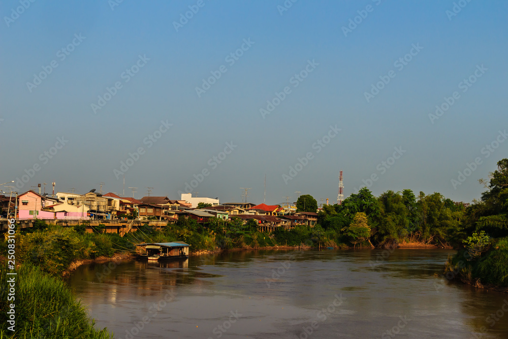 Fototapeta premium Landscape of Muang district, Phichit province, Thailand in summer with colorful houses and a blue sky on Nan river bank. Phichit is a province of Thailand and far 330 km from Bangkok.
