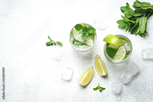 Mojito cocktail with mint and lime on a light background Copy space top view.