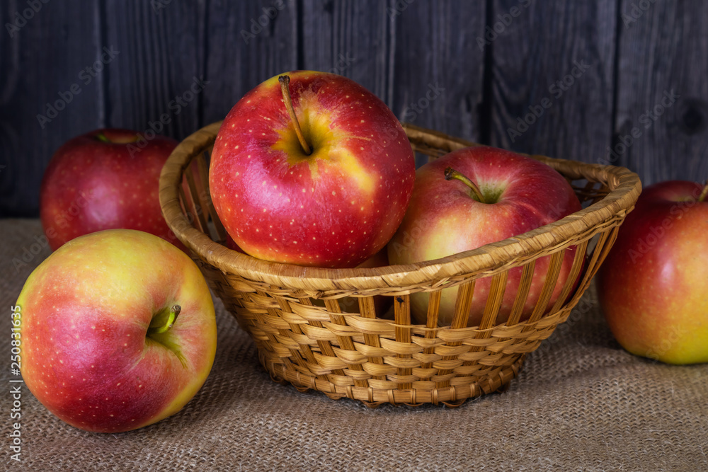 Red-yellow ripe apples in and around the basket Red-yellow ripe apples in and around the basket
