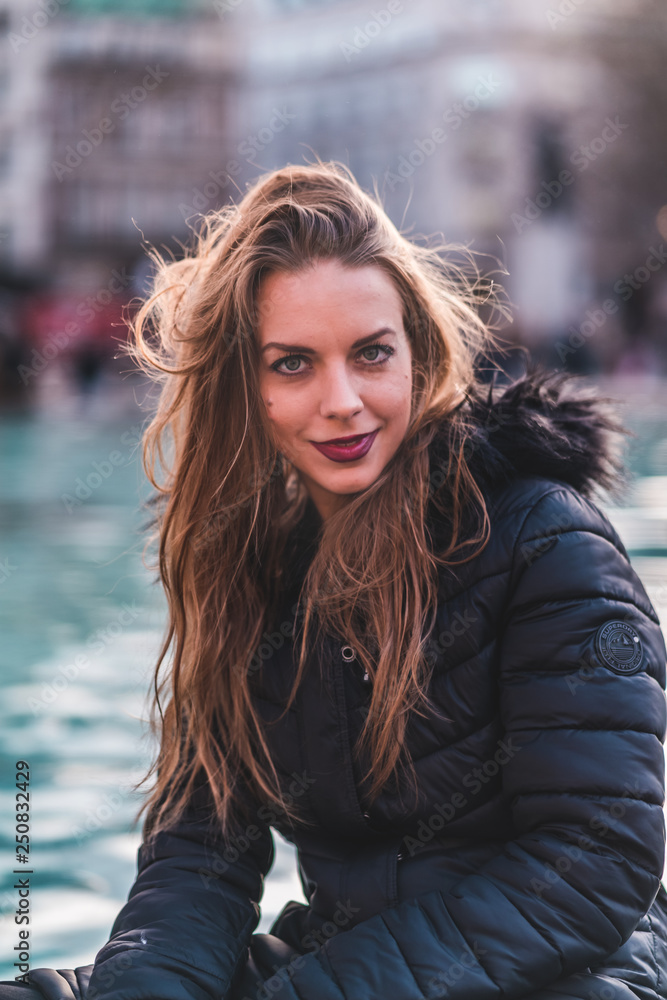 fashionable portrait of young beautiful woman in a European city on a sunny winter day fashionable portrait of young beautiful woman in a European city on a sunny winter day