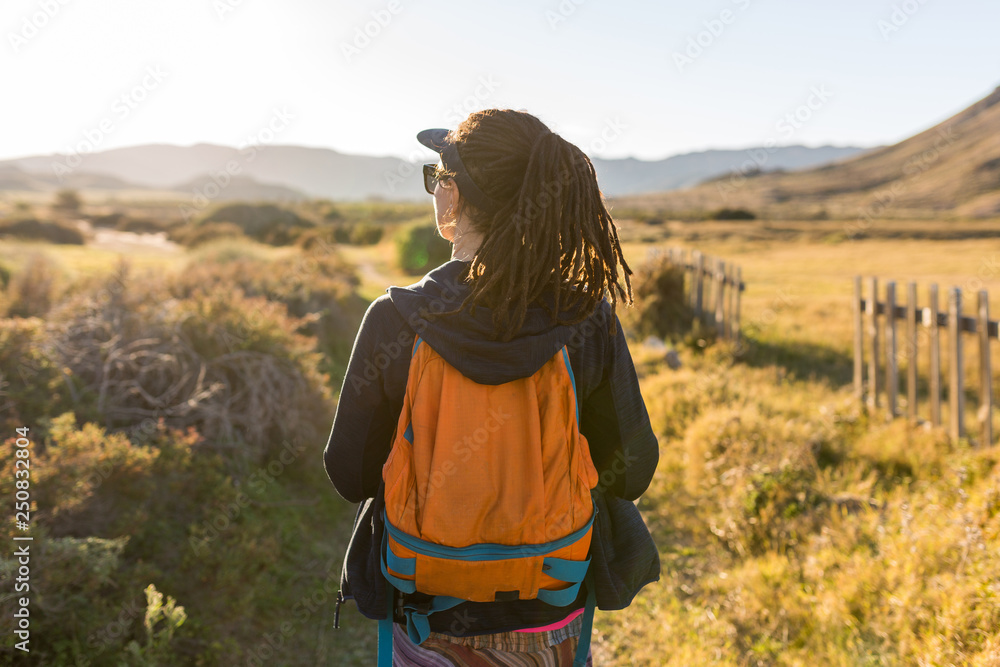 Rear view of a woman admiring Spanish landscape, Rambla del Playazo, Cabo de Gata - Nijar Natural Park, Spain