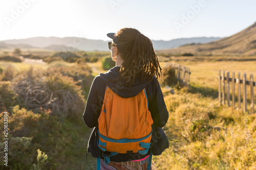 Rear view of a woman admiring Spanish landscape, Rambla del Playazo, Cabo de Gata - Nijar Natural Park, Spain photo