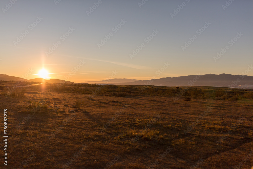 Obraz premium Sun hiding between mountains, sunset in Cabo de Gata-Nijar Natural Park, Andalusia, Spain