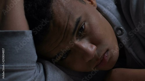 Depressed afro-american teenager thinking about life problems, mental health