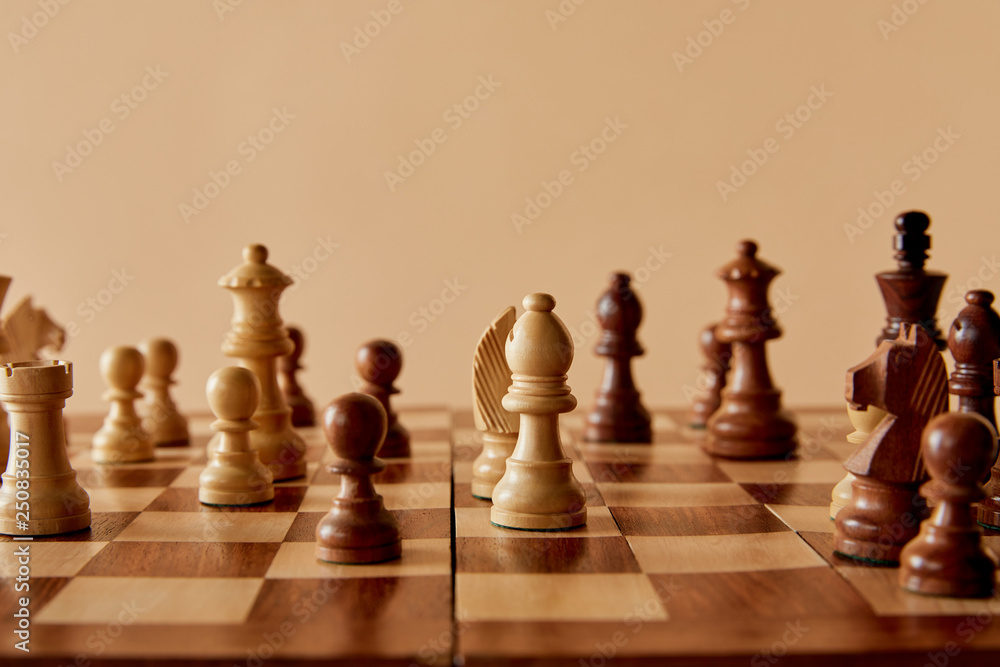 selective focus of wooden chess on board and beige background