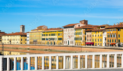 Old buildings in Pisa reflected in the Arno River