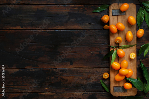 Kumquat fruits on an old wooden  background