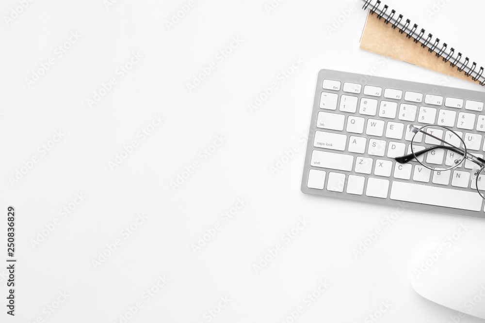 White office desk table with computer mouse, keyboard and supplies. Top view with copy space, flat lay. White office desk table with computer mouse, keyboard and supplies. Top view with copy space, flat lay.