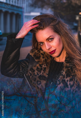 fashionable portrait of young beautiful woman in a European city on a sunny winter day