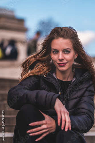fashionable portrait of young beautiful woman in a European city on a sunny winter day