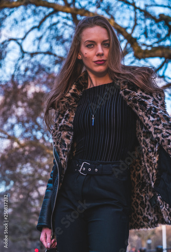 fashionable portrait of young beautiful woman in a European city on a sunny winter day