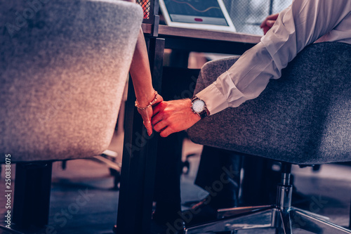 Φωτογραφία Close up of office workers that holding hands