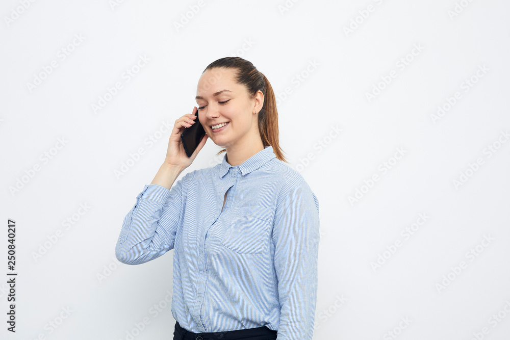 smiling young woman talking on cell phone isolated on white smiling young woman talking on cell phone isolated on white