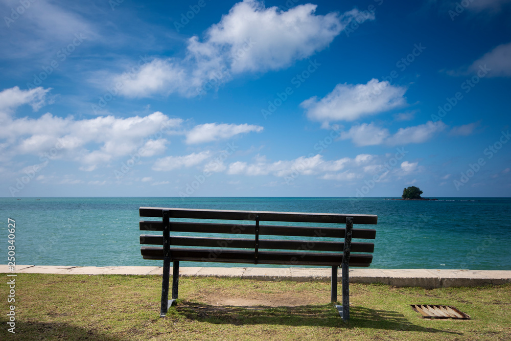 Wooden bench in front of the sea Wooden bench in front of the sea