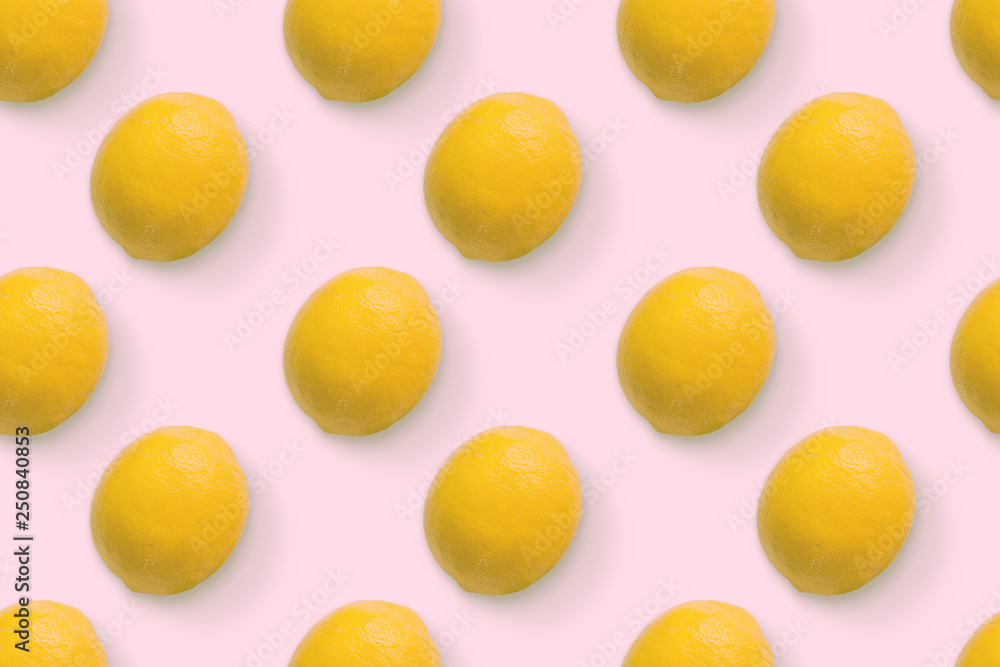 Creative seamless pattern of lemons. Minimal summer concept.  Lemon on pastel pink background.Flat lay.Top view.