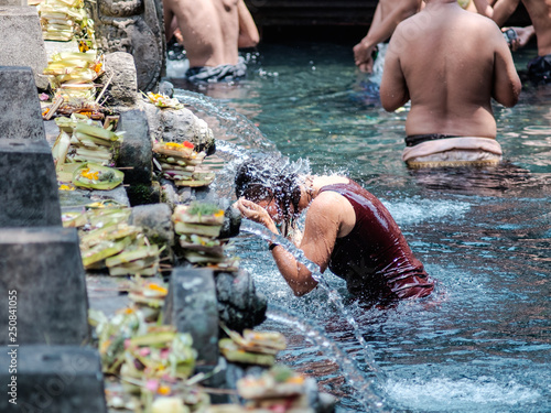 Tourist perfoming melukat at Pura Tirta Empul