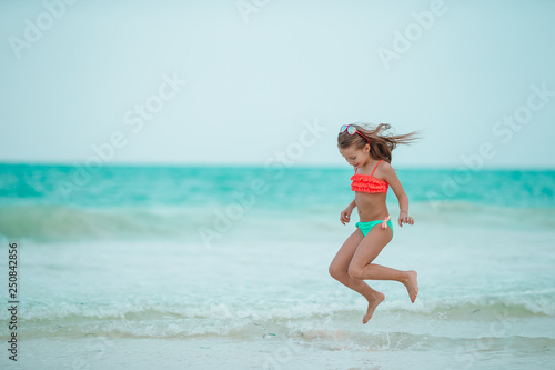 Adorable little girl at beach during summer vacation