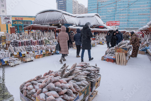 Yakutsk, Republic of Yakutia, Russia. 01.16.2019.The coldest market in the world is in the city of Yakutsk. It sells fresh-frozen fish, meat, berries. The temperature drops to -57 degrees. photo