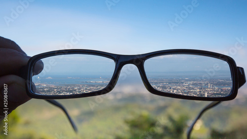 shortsighted eye glasses sharp panorama view over Cebu City with out of focus photo parts 