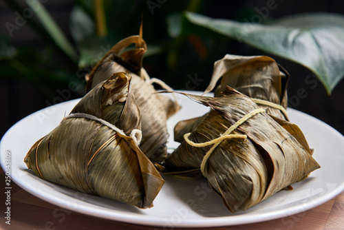 Traditional chinese rice dumplings zongzi on the white plate   photo