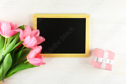 Fresh flower composition, bouquet of bi color pink tulips, white wooden texture table background. International Women's day, mother's day greeting concept. Copy space, close up, top view, flat lay.