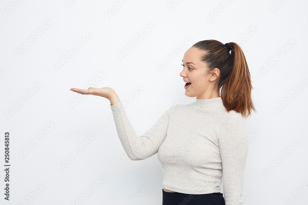 portrait of young woman presenting copyspace looking at product portrait of young woman presenting copyspace looking at product