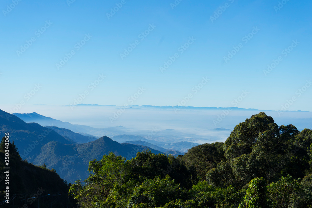 Panoramic scenery of the mist shrouded mountains at sunset in northern Thailand
