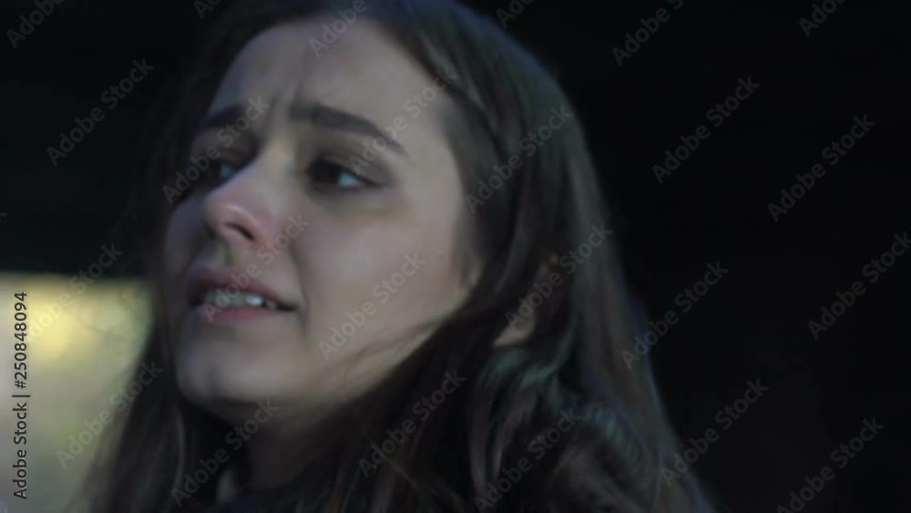 Frustrated lady walking along busy street looking at cars, lonely and frightened Frustrated lady walking along busy street looking at cars, lonely and frightened