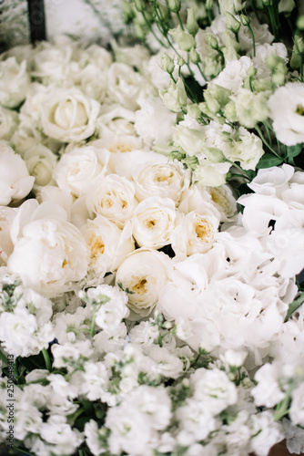 Beautiful fresh blossoming flower bed of hydrangea, eustoma, david austin roses, peony, mattiola, carnations in white color, top view, flat lay; Fresh delivery at the flower shop