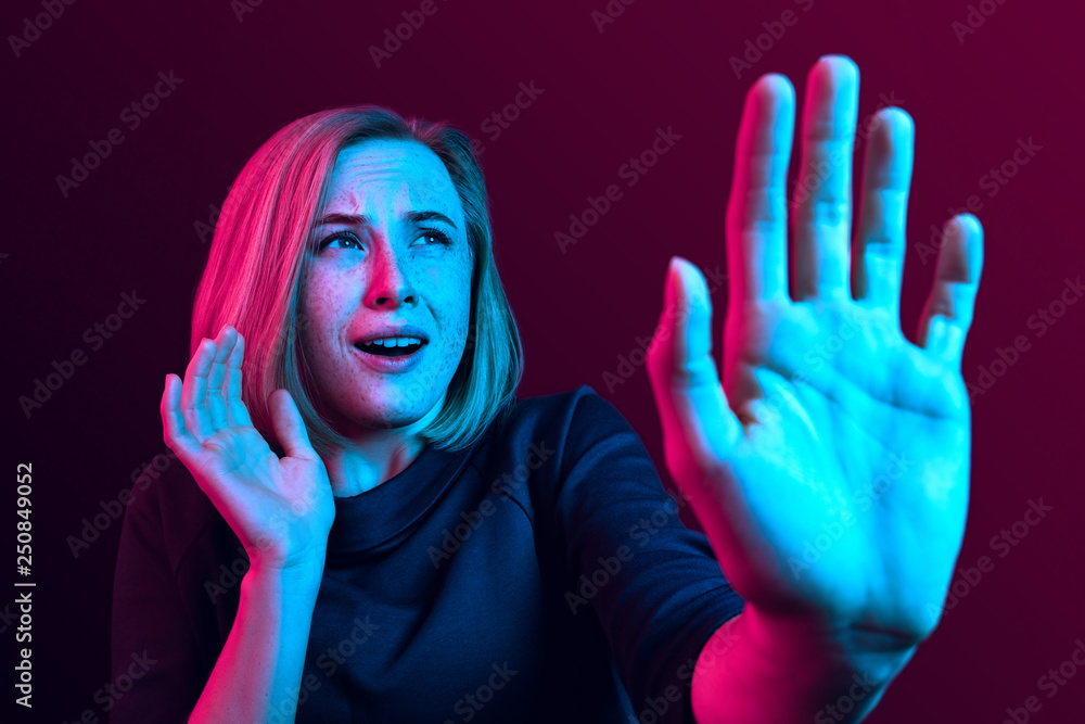 I'm afraid. Fright. Portrait of the scared woman. Business woman standing isolated on trendy neon studio background. Female half-length portrait. Human emotions, facial expression concept I'm afraid. Fright. Portrait of the scared woman. Business woman standing isolated on trendy neon studio background. Female half-length portrait. Human emotions, facial expression concept