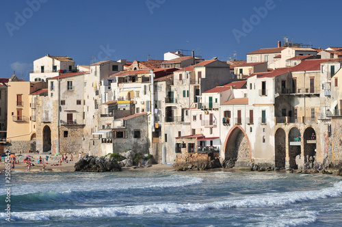 Houses along the shoreline Cefalu Sicily, Italy. photo