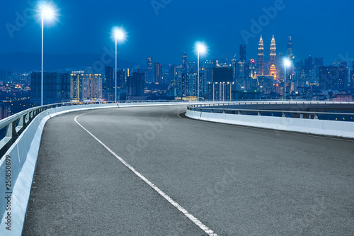 Photography High speed corner overpass asphalt road with Kuala Lumpur cityscape , night scene