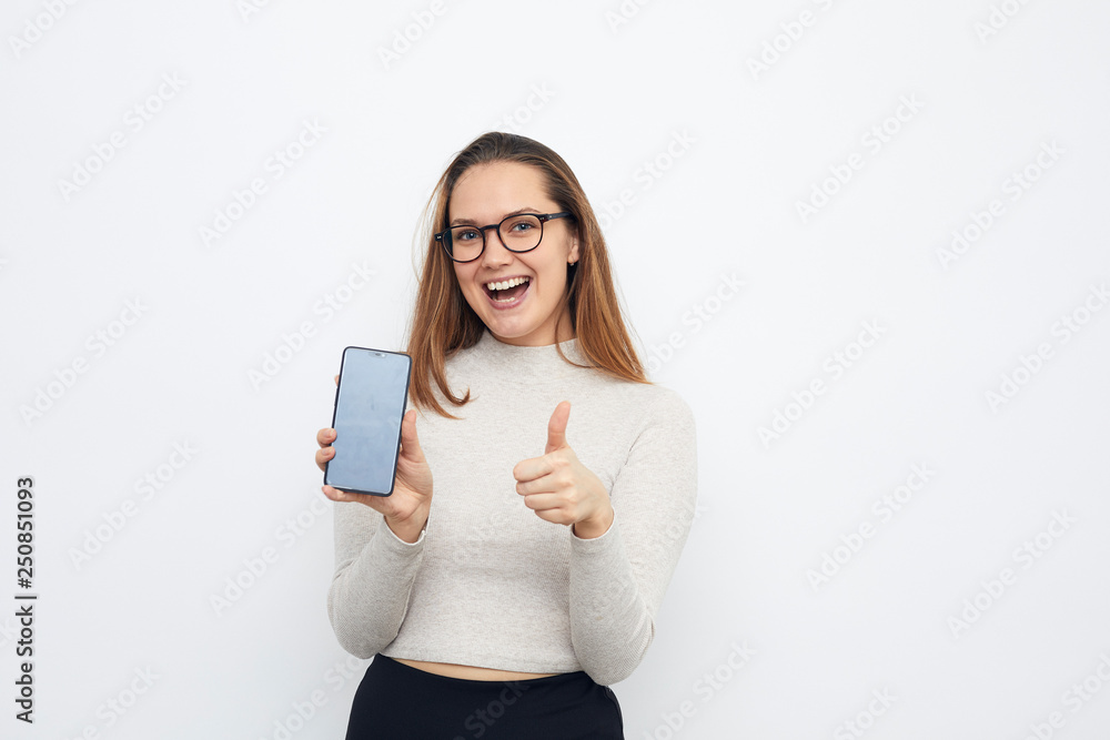 happy young woman with cellphone making thumbs up
