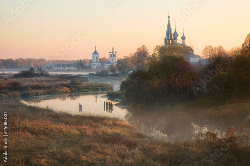 old churches at fog sunrise in Dunilovo, Russia