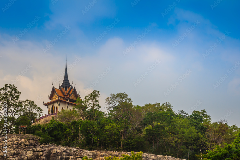 Beautiful white buddhist pavilion on the hilltop with blue sky background at Wat Phraputthachai temple, Saraburi, Thailand. This temple is public for entry and tourist can enjoy the 360-degree view.