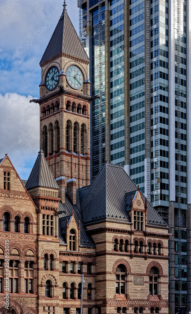 The Old City Hall in Toronto contrasts with the modern architecture that surrounds it - behind is the Bank of Montreal (BMO) Building