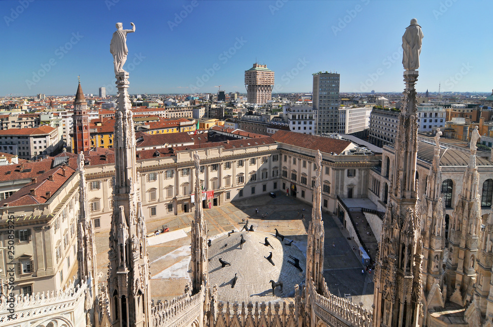 View of Milan skyline spires and statues from the top of Milan Cathedral, Italy.