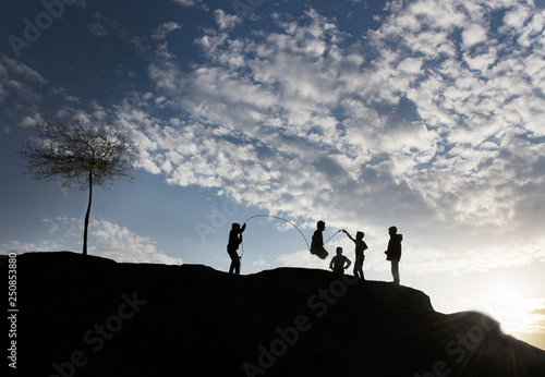 silhouette of man on top of mountain