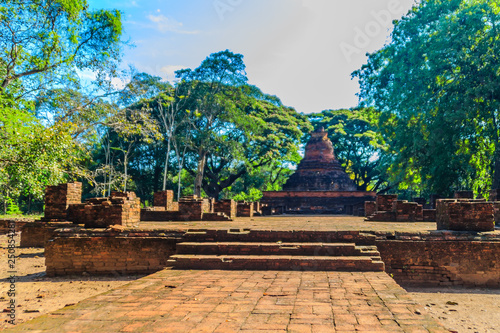 Lanka style ruins pagoda of Wat Mahathat temple in Muang Kao Historical Park, the ancient city of Phichit, Thailand. This tourist attraction is public historic site and free admission. photo