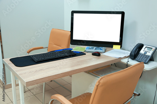 Doctor's workplace with computer in modern clinic. Space for design