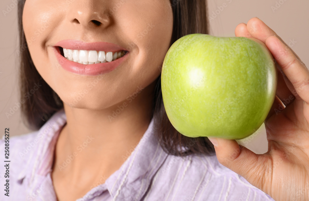 Young woman with healthy teeth and apple on color background, closeup Young woman with healthy teeth and apple on color background, closeup