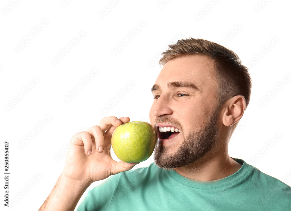 Young man with healthy teeth and apple on white background Young man with healthy teeth and apple on white background