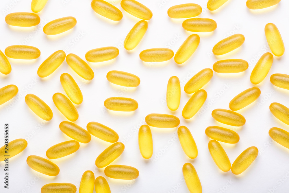 Omega 3 capsules on white background Fish oil Yellow softgels Vitamin D, E, A supplement Concept of healthcare Omega 3 capsules on white background Fish oil Yellow softgels Vitamin D, E, A supplement Concept of healthcare