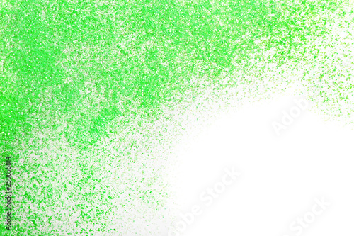 Green glitter on white background, top view