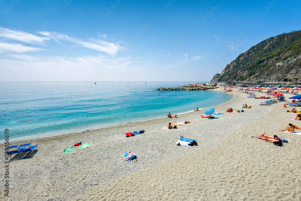 People swimming and having fun at the beach of Monterosso al Mare, Italy. Monterosso al Mare is a town and comune in the province of La Spezia, It is one of the five villages in Cinque Terre.