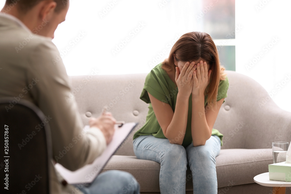 Psychotherapist working with woman in light office Psychotherapist working with woman in light office