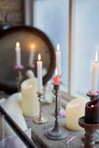 burning candles in silver candlesticks