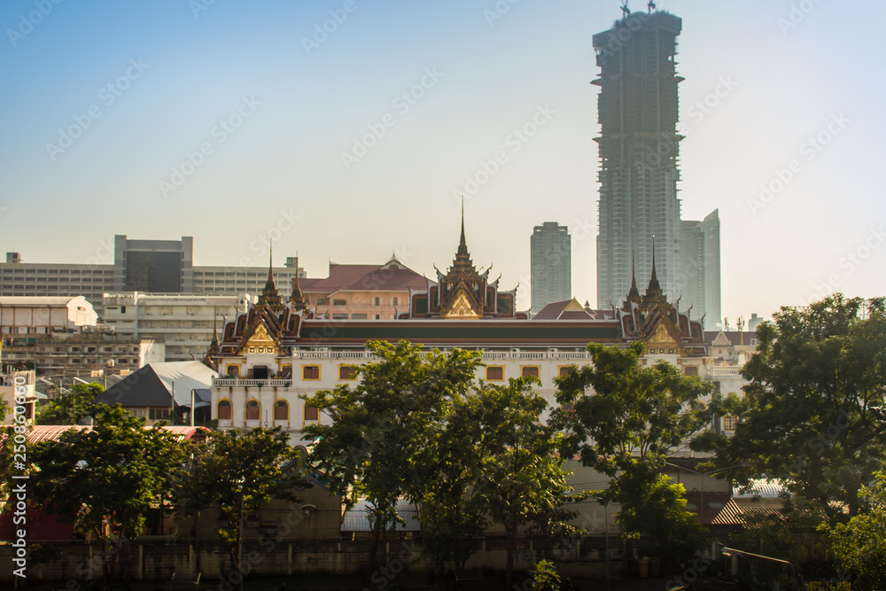 Bangkok, the city of contrasts. Ancient temple stand with new hi-rise condominium building construction.
