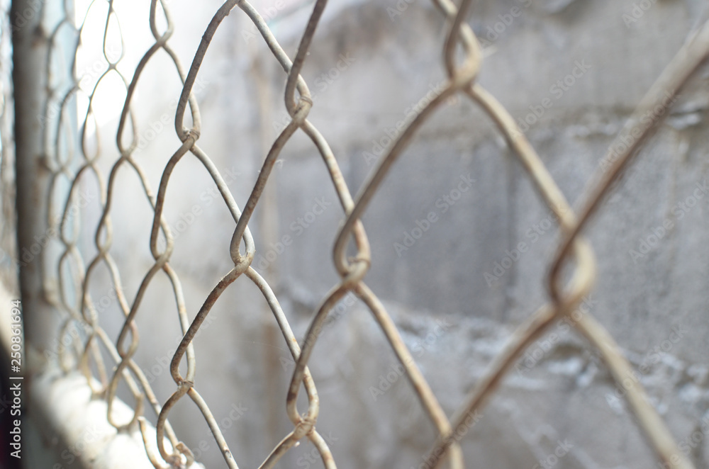 Fototapeta premium Cream colored steel fence on brick wall backgrounds