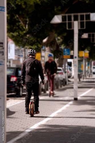 Wallpaper Mural The guy rides on the sidewalk on a monowheel Torontodigital.ca